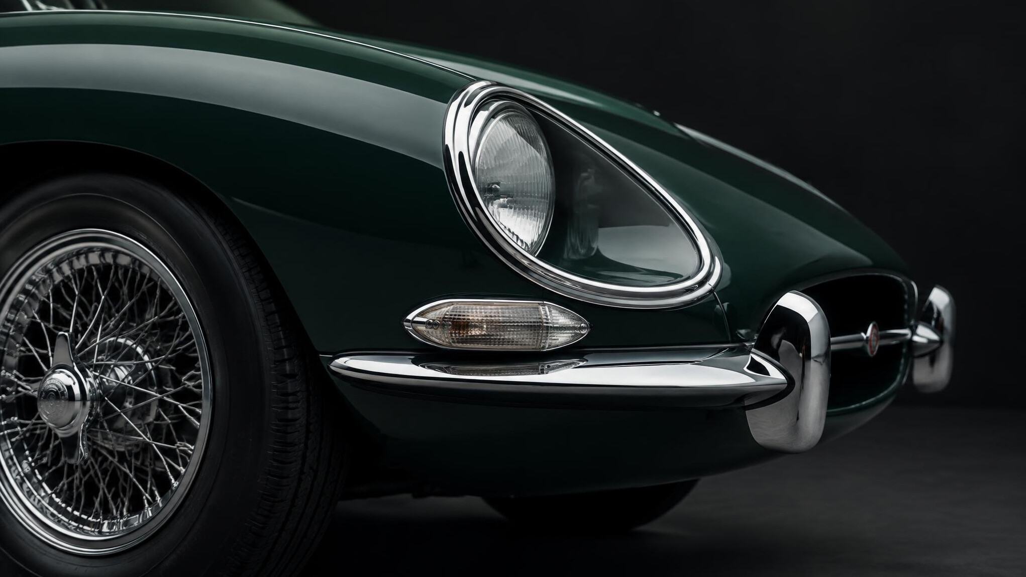 Side profile detail of a 1960s classic sports car chrome bumper and headlight