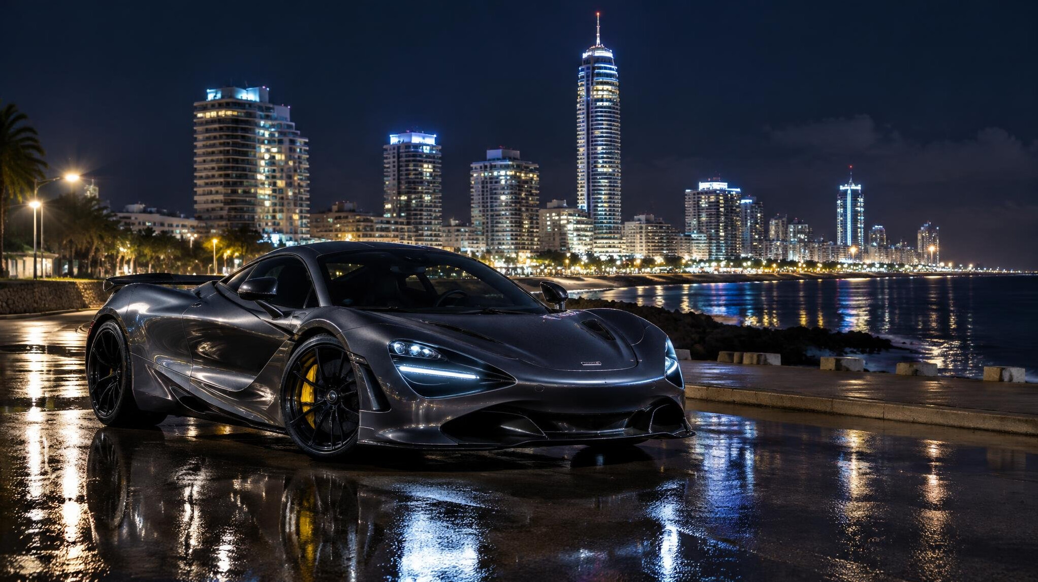 Modern hypercar parked at night near the illuminated towers of Punta del Este